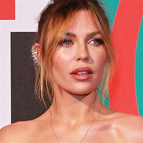 Abbey Clancy poses topless in statement 70s flares – and wow